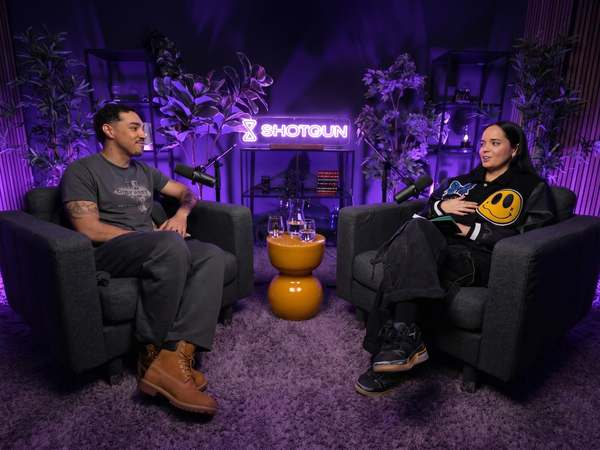 Two people recording a video interview under purple lighting at Kreators by bridgr in Lisbon