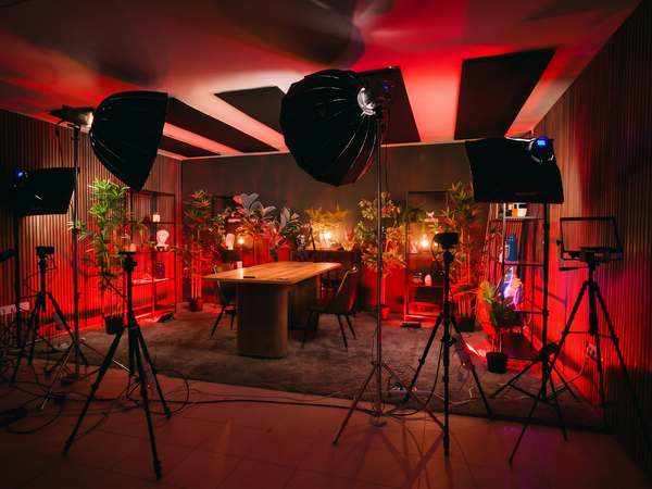 Podcast recording set with red lighting and cameras at Kreators by bridgr in Alfama, Lisbon
